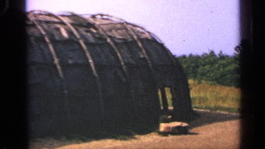 1969: footage of an old farming shed sitting in disrepair in a field.