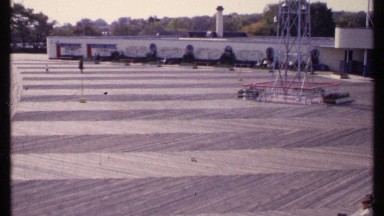 1969: people sitting on a ledge waiting for others to pass by NEW LONDON