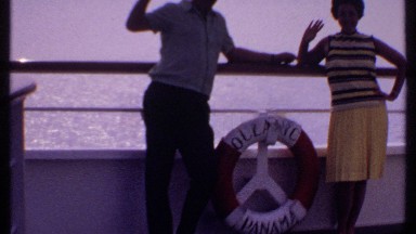1969: a husband and wife standing at the boat in the middle of water and say bye