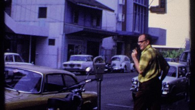1969: a man standing platform of the road and using walkie-talkie for speaking