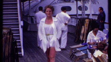 1969: a beautiful lady wearing white clothes walking through the platform