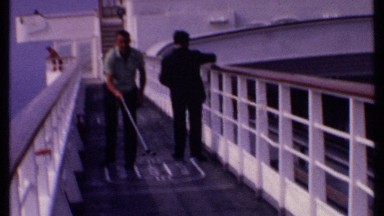 1969: man plays shuffleboard of a cruise ship. BAHAMAS
