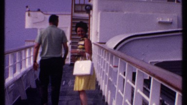 1969: couple turns around waves to camera about to board a ship BAHAMAS