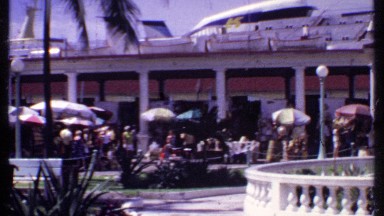 1969: a big shopping center with large building with people purchasing goods