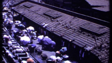 1969: Workers Beat Laundry on Stone Tubs at Outdoor Facility in India