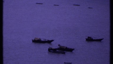 1969: ships sit in the water off the coast INDIA
