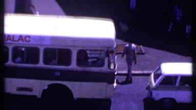 1969: pedestrians walking amid many vehicles parked on the roadside KENYA