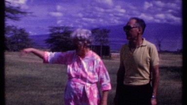 1969: a senior couple calling out to their son and posing for a picture