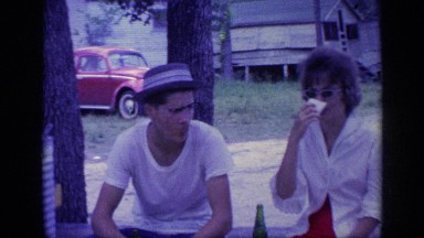 1968: Boy and Girl Sitting, Drinking, and Talking in Nature Florida