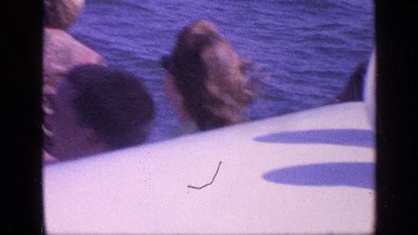 1968: young people are riding on vessel with the wind blowing their faces