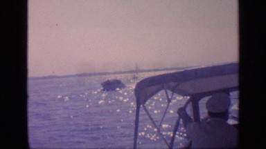 1968: group of sea men on a small boat passing by others FLORIDA