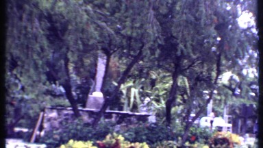 1969: a bunch of cars parked in front of palace, a guy is walking