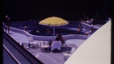 1969: footage of people relaxing poolside at a resort. BAHAMAS