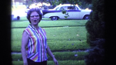 1968: old woman smiles on front lawn FLORIDA