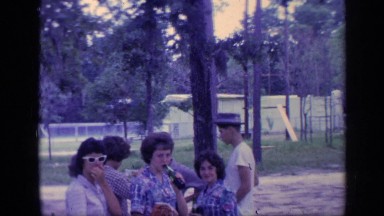 1968: a group of people gathered together in a place, some eating ice cream