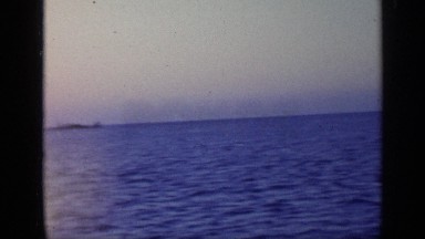 1968: a stunning view of an ocean and an island, with the camera finally landing