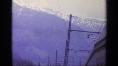 1962: Passengers Enjoy Snowy Mountain View from Inside Train Car
