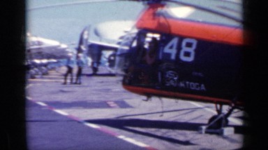 1962: panning view of the top of an aircraft carrier with planes