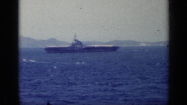 1962: a large ship moving through the water of the blue sea ITALY