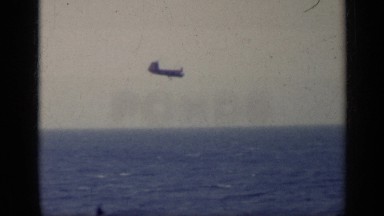 1962: a fighter jet ready for landing on an aircraft carrier in the deep sea