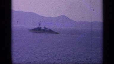 1962: grainy footage of navy vessel at sea on sunset. ITALY