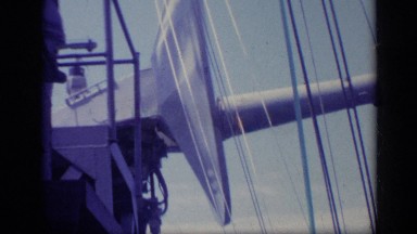1962: a man pushing something off from the deck of a ship in the sea ITALY
