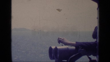 1962: a sweeping view of men and jets parked on a military aircraft carrier