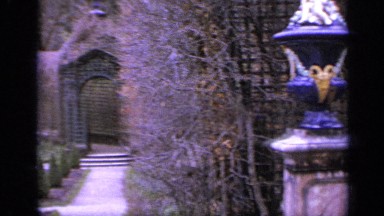 1962: spacious courtyard filled with statues and manicured landscaping centered