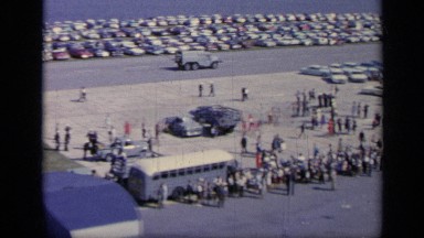 1962: Huge Crowd on Italian Riverbank During Public Occasion
