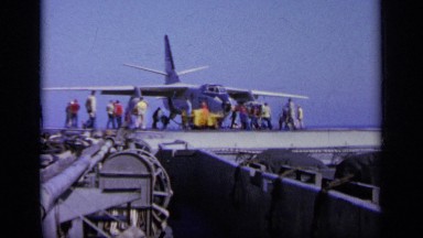 1963: People Crowd Around as Plane is Safely Moved on Ship Deck GREECE
