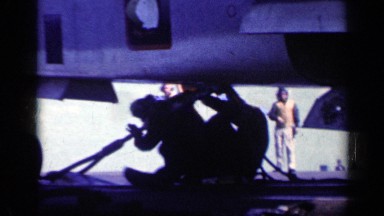 1962: Crew Works on Aeroplane Aboard Navy Vessel at Sea in Cuba