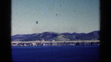 1962: A Large Black Helicopter Flying Over a Body of Water in Cuba