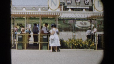1959: a woman gives her ticket to the man at the gate to get inside the resort