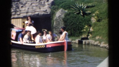 1959: a woman with a microphone gives a tour to the people on the boat