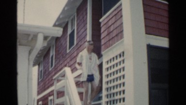 1959: child walking down a flight of stairs and then walking down the sidewalk