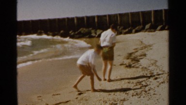 1959: two boys skipping stones off the water at the beach. SAN FRANCISCO