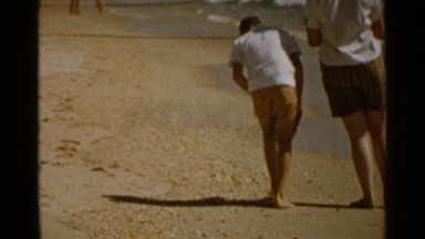 1959: the two boys are walking and playing on the seashore SAN FRANCISCO