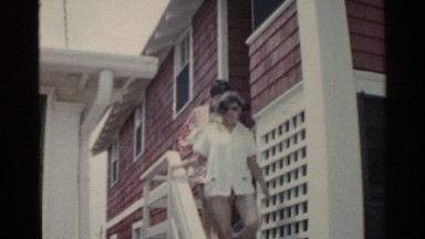 1959: two happy women walk down a staircase past the camera and down the street.