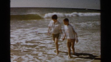 1959: people walking in the seashore SAN FRANCISCO