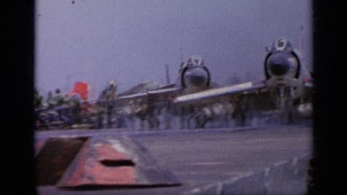 1962: A Group of People Congregating Around Airplane Preparations