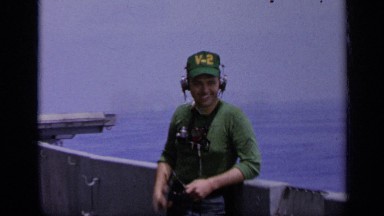 1962: a man speaking with use of hear phone at working place and also happy
