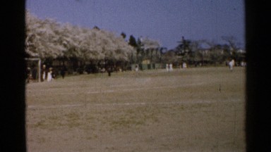 1952: a vast soccer ground surrounded by many trees under the clear sky JAPAN