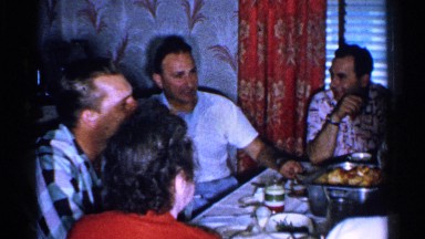 1952: a group of men and women sitting around a dinner table enjoying a meal