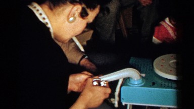 1952: a couple appears to be assembling a colorful child's record player