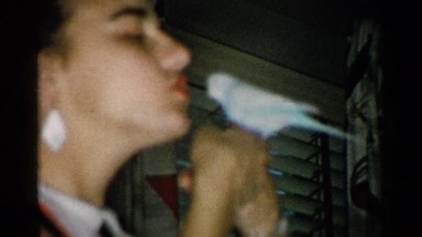 1952: a white women playing and speaking with a nice bird walking in her hand