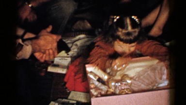 1952: cute little girl sitting on the floor, opening a gift box NEW HAMPSHIRE