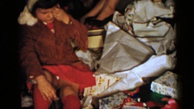 1952: family opening presents on christmas morning and enjoying each other's