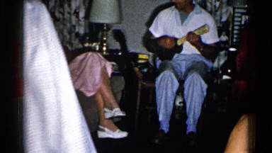 1952: a person playing a musical instrument while a couple of ladies are dancing