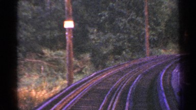 1953: long curved railway tracks running through an area with lot of trees