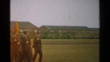 1952: military men walking with flag and doing parade